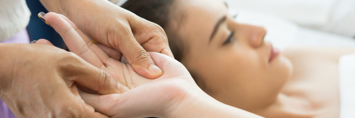 Young woman receiving hand massage in spa.